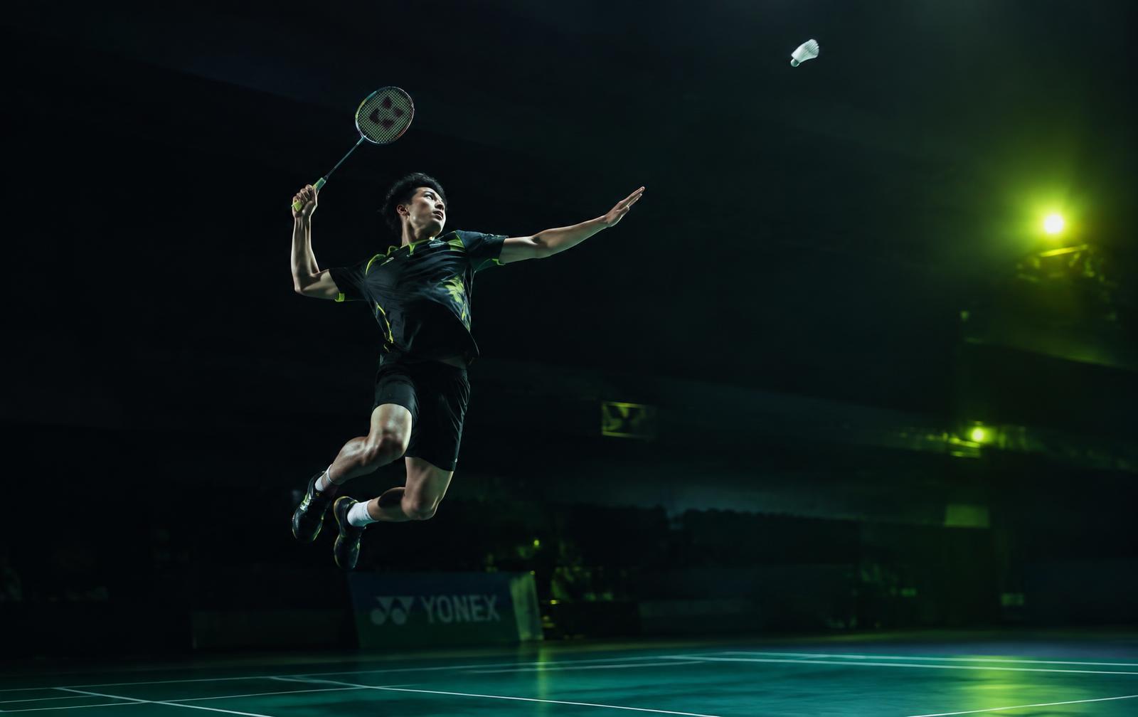 Badminton player mid-smash